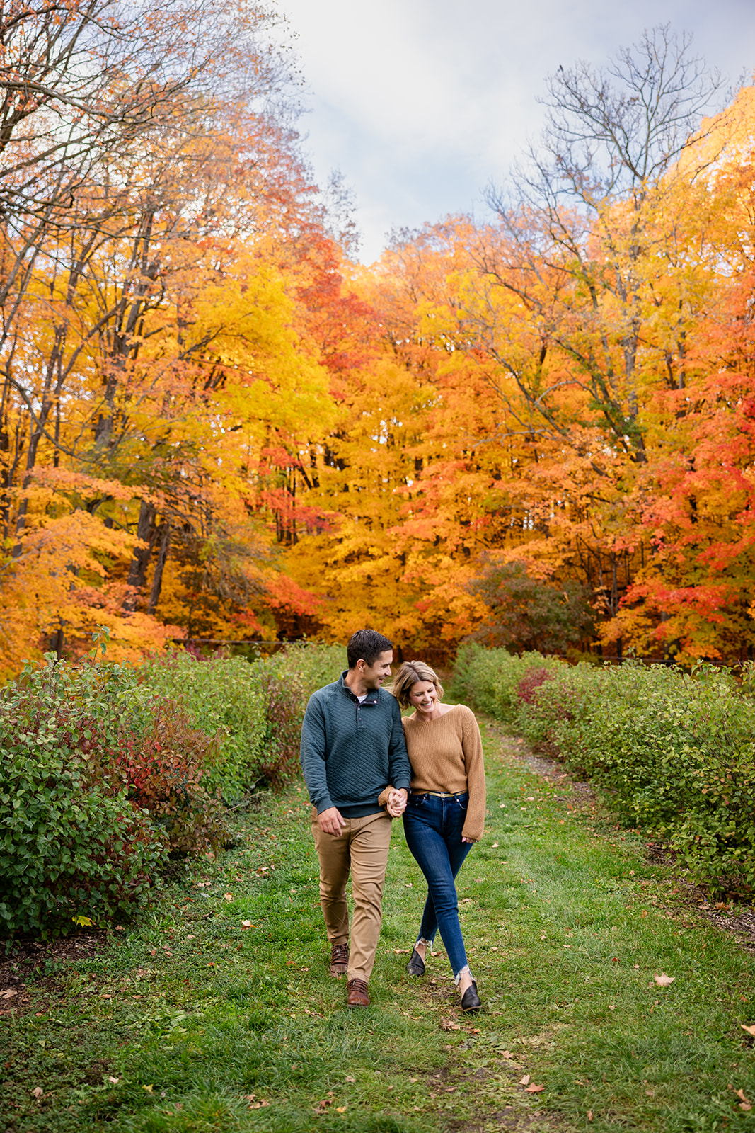 Bright orange fall trees engagement session couples picture.