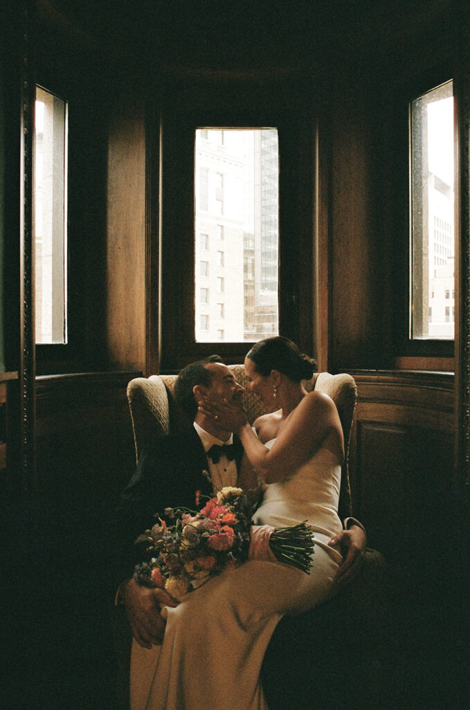 bride and groom portrait sitting on chair taken on film