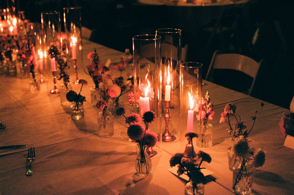 late night moody candles at the dinner tables during a wedding reception taken on film