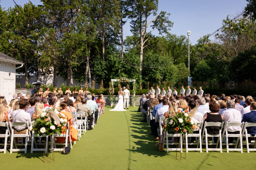 bride and groom standing at the alter at the outdoor ceremony space at the hutton house