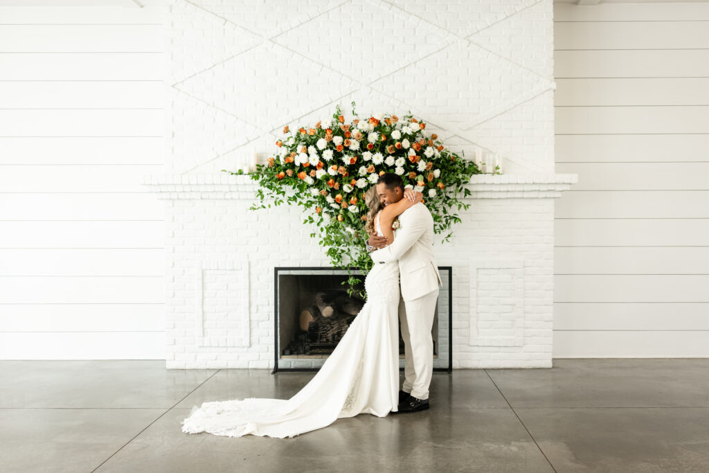 bride and groom share a first look at the fireside room at the hutton house