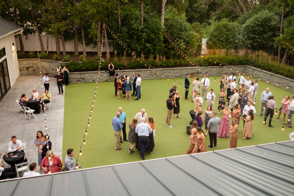 people standing outside at the hutton house outdoor lawn during the reception